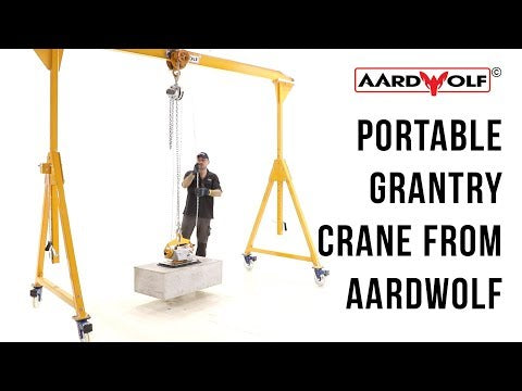 Portable gantry crane for transporting, lifting slab materials in different heavy-duty conditions